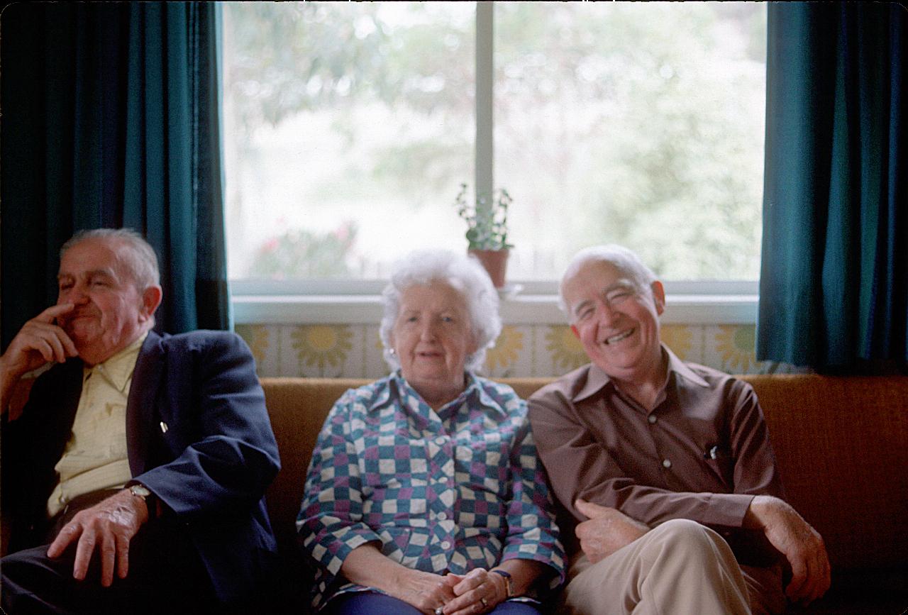 Two men and a woman on a lounge