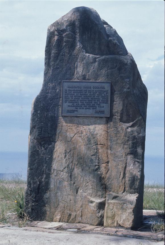 Large rock, like a pillar, with a plaque on it