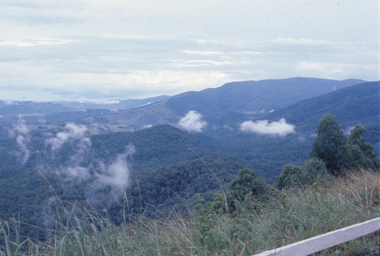 Looking down over hills, with clouds below