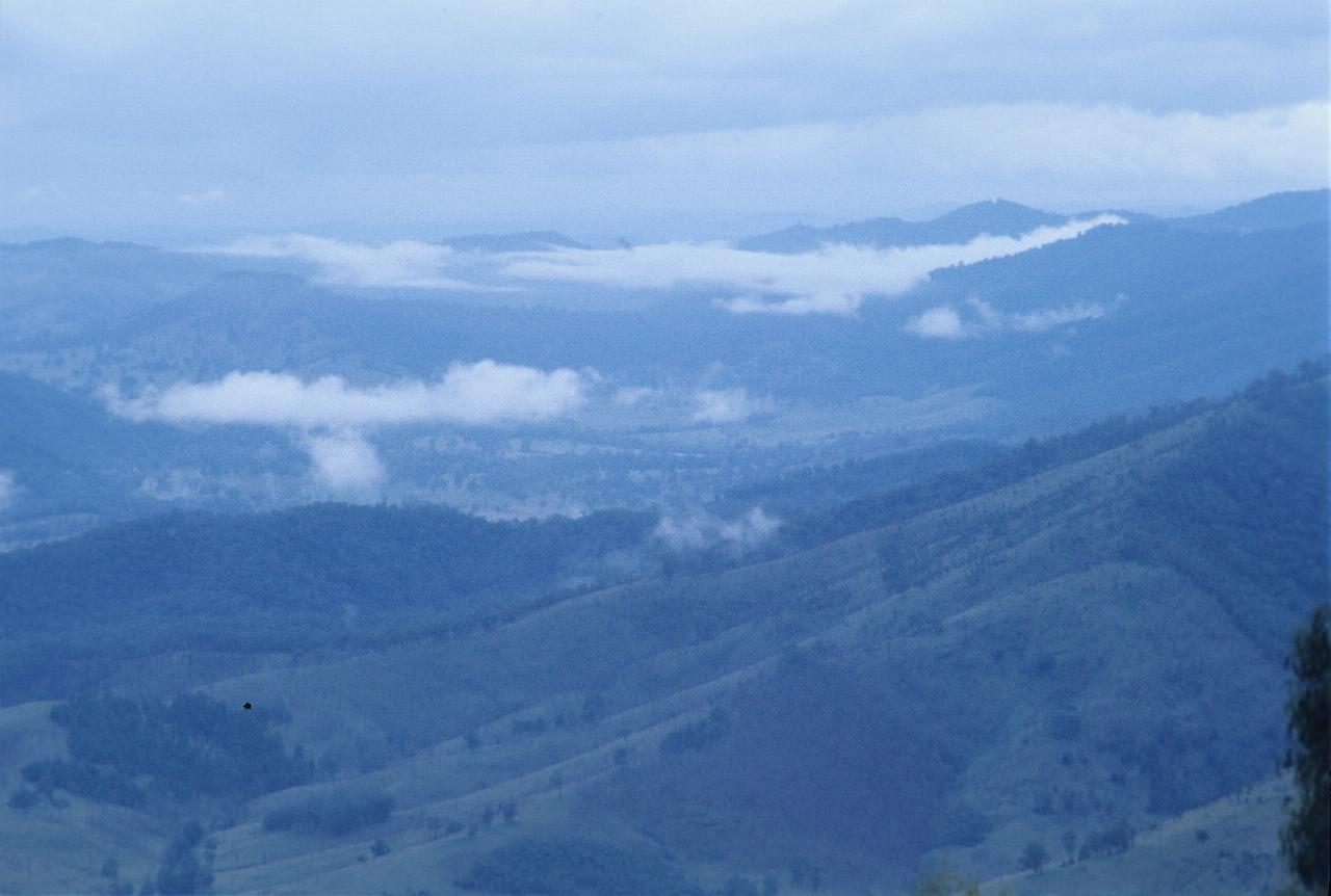 Looking down to hills and valleys, with low clouds and overcast sky