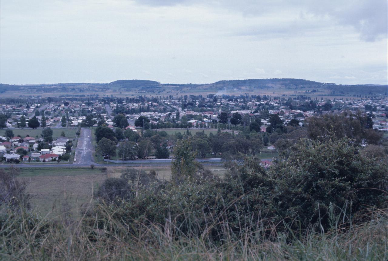 View from hill overlooking town to distant hills