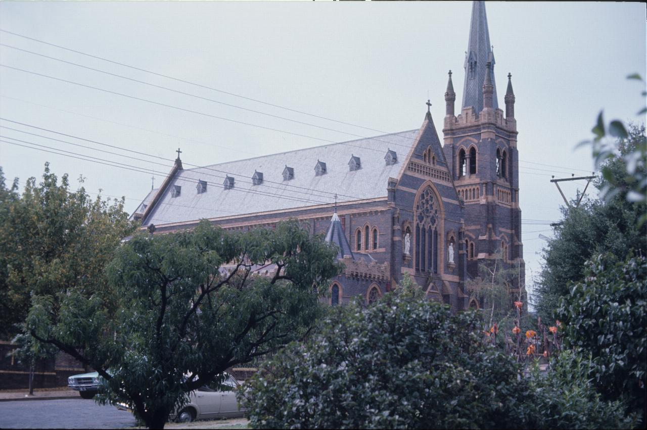 Tall, brick and stone building with spire