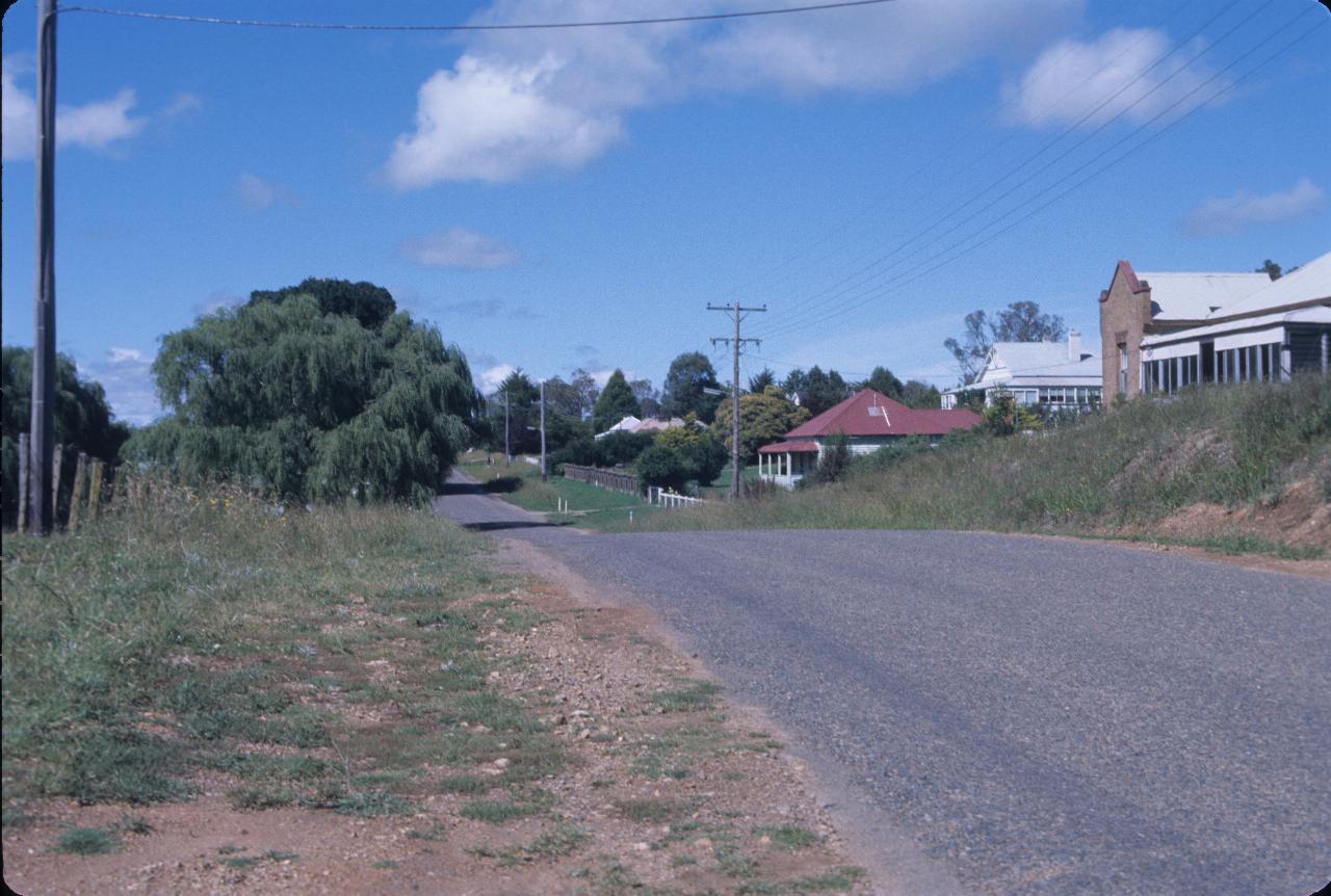 Several houses on right side of road.