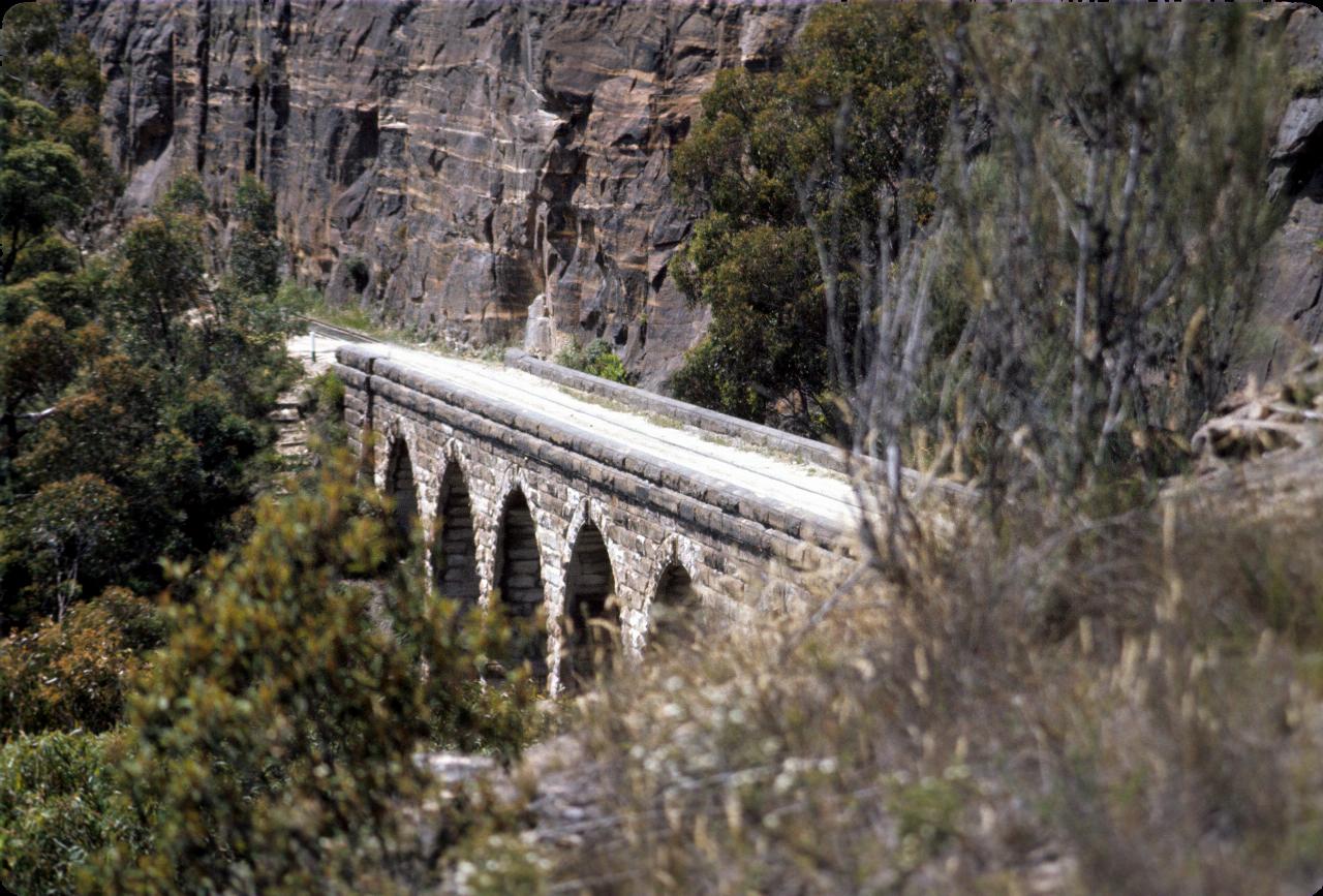 Bridge of standstone blocks, cut into rock face