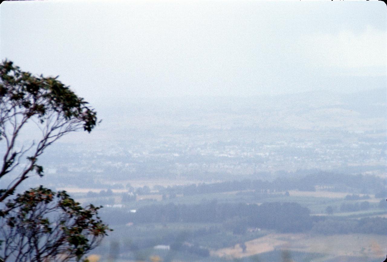 Distant countryside, barely visible due to rain