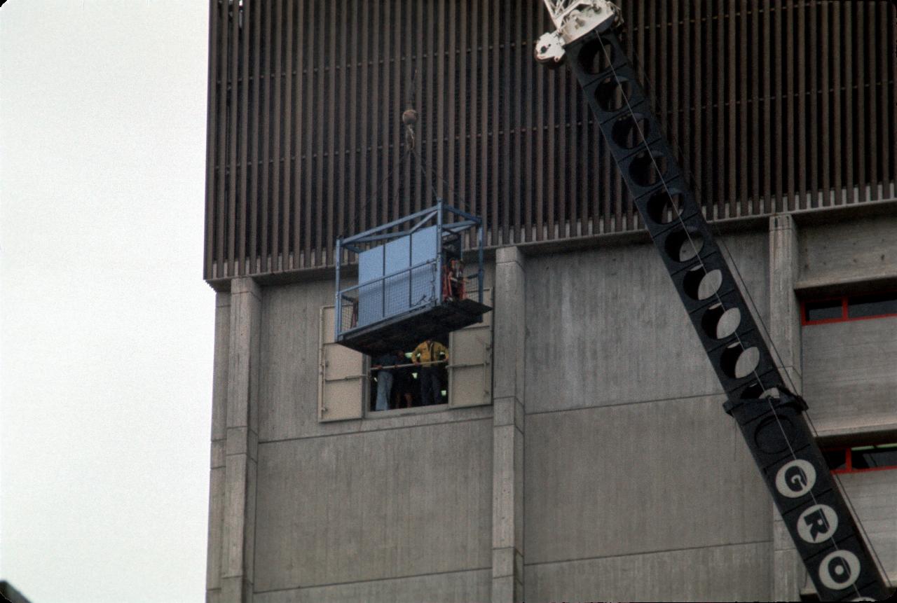 Part of air conditioner being lifted in