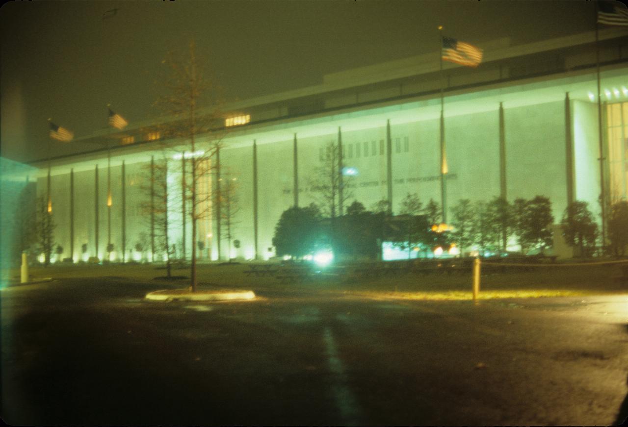 Long building with central entrance, flat walls and pillars