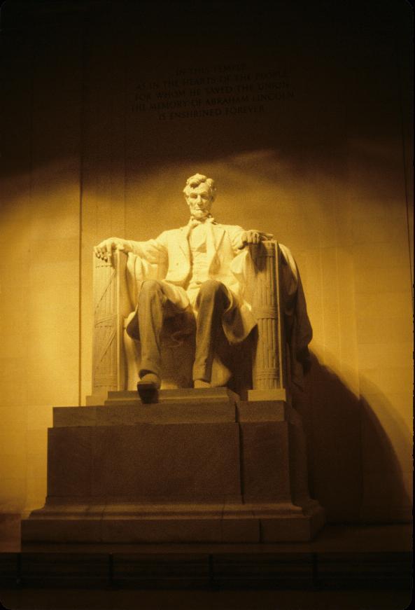 Large statue of bearded man sitting in large chair