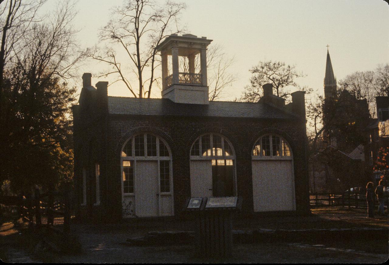 Small building with 3 wide doors and lookout post on the roof