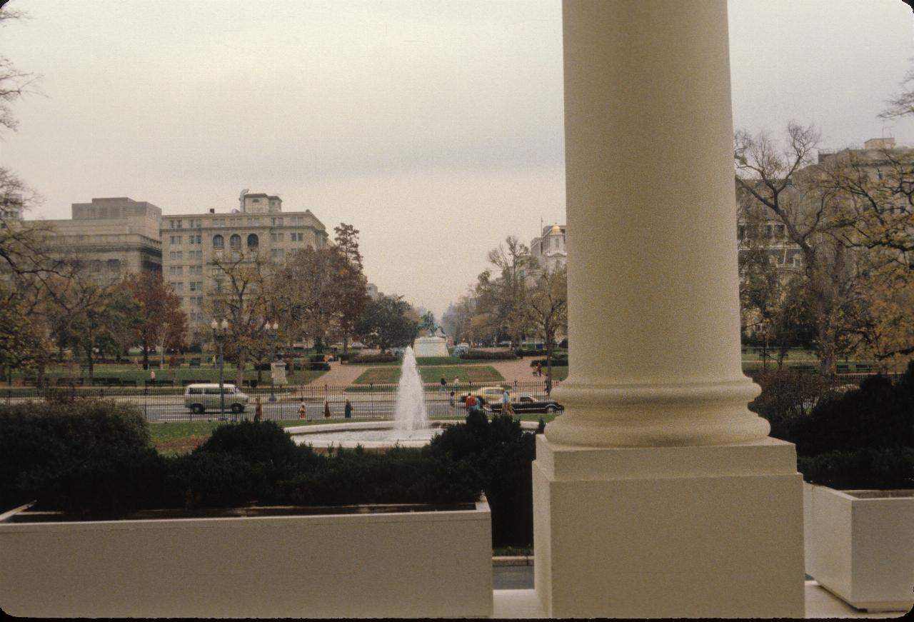 View past thick pillar to fountain and park across the road