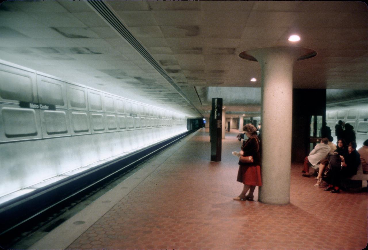 Underground train station, red platform tiles, bright white walls