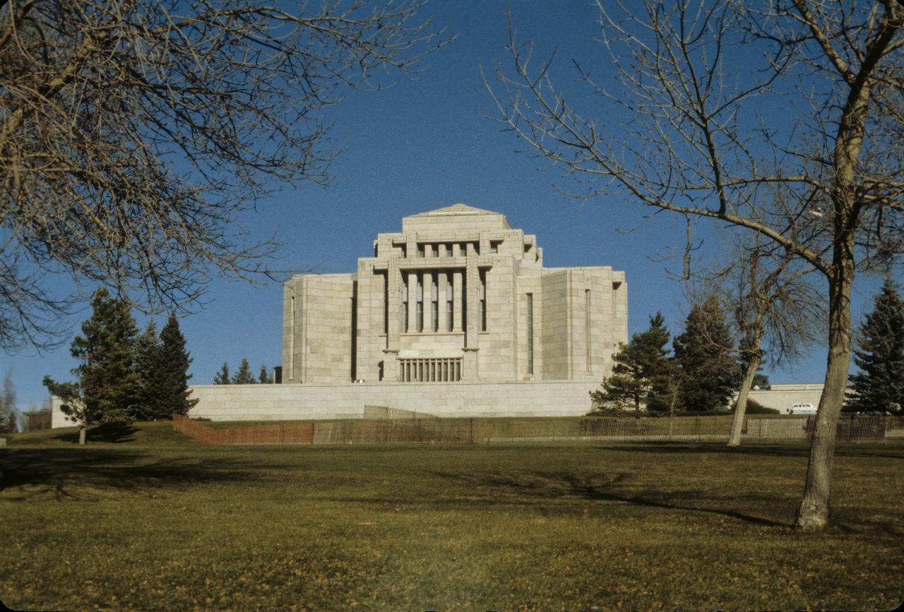 White building with prominent square columns, several stories high