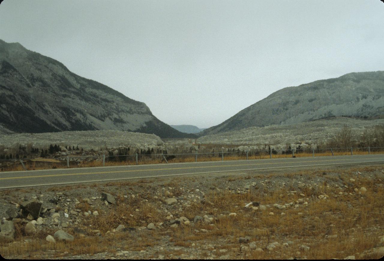 Rocks from the mountain line the side of the road