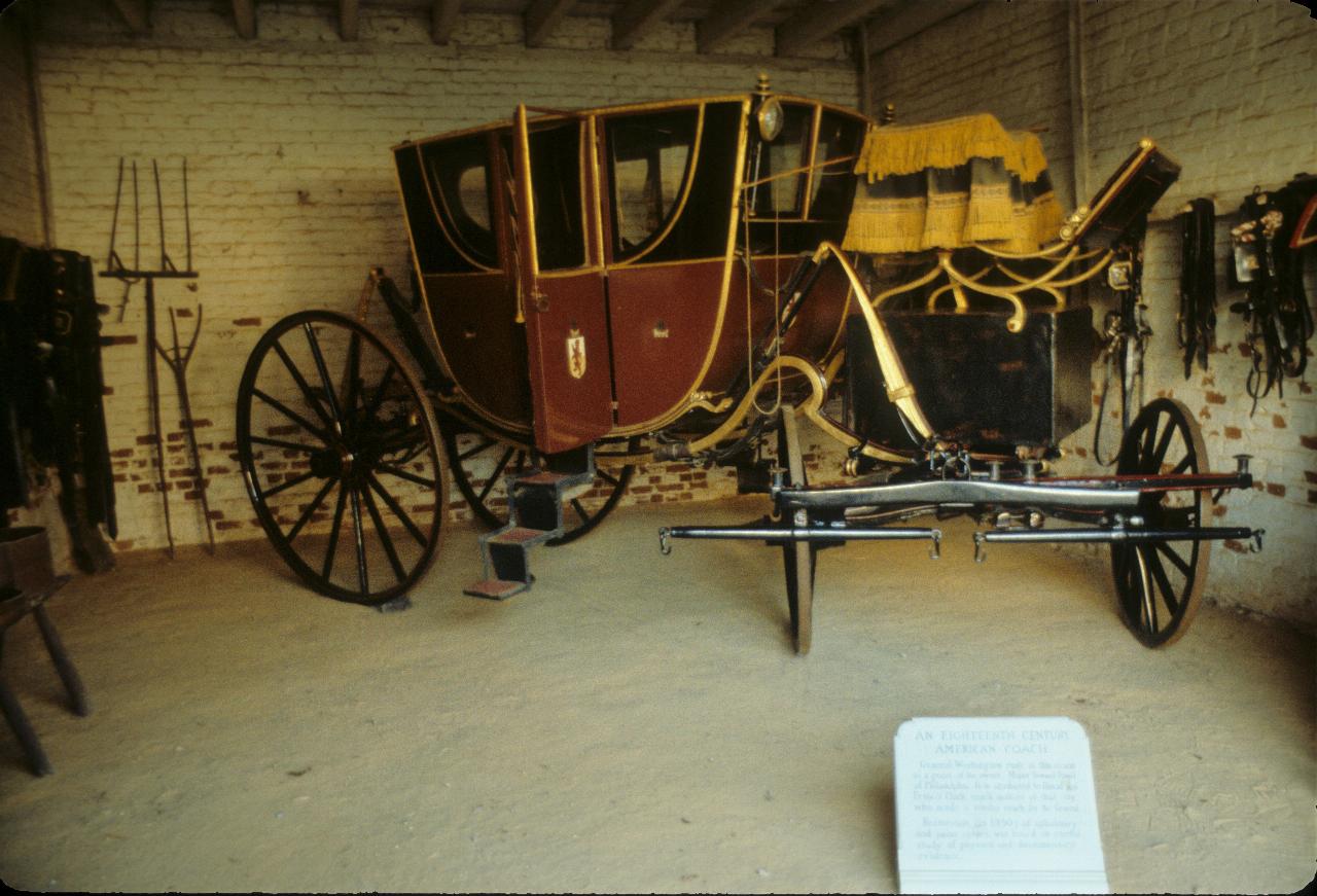 Horse drawn carriage in a stable, with entry stairs lowered ready for somebody to climb in