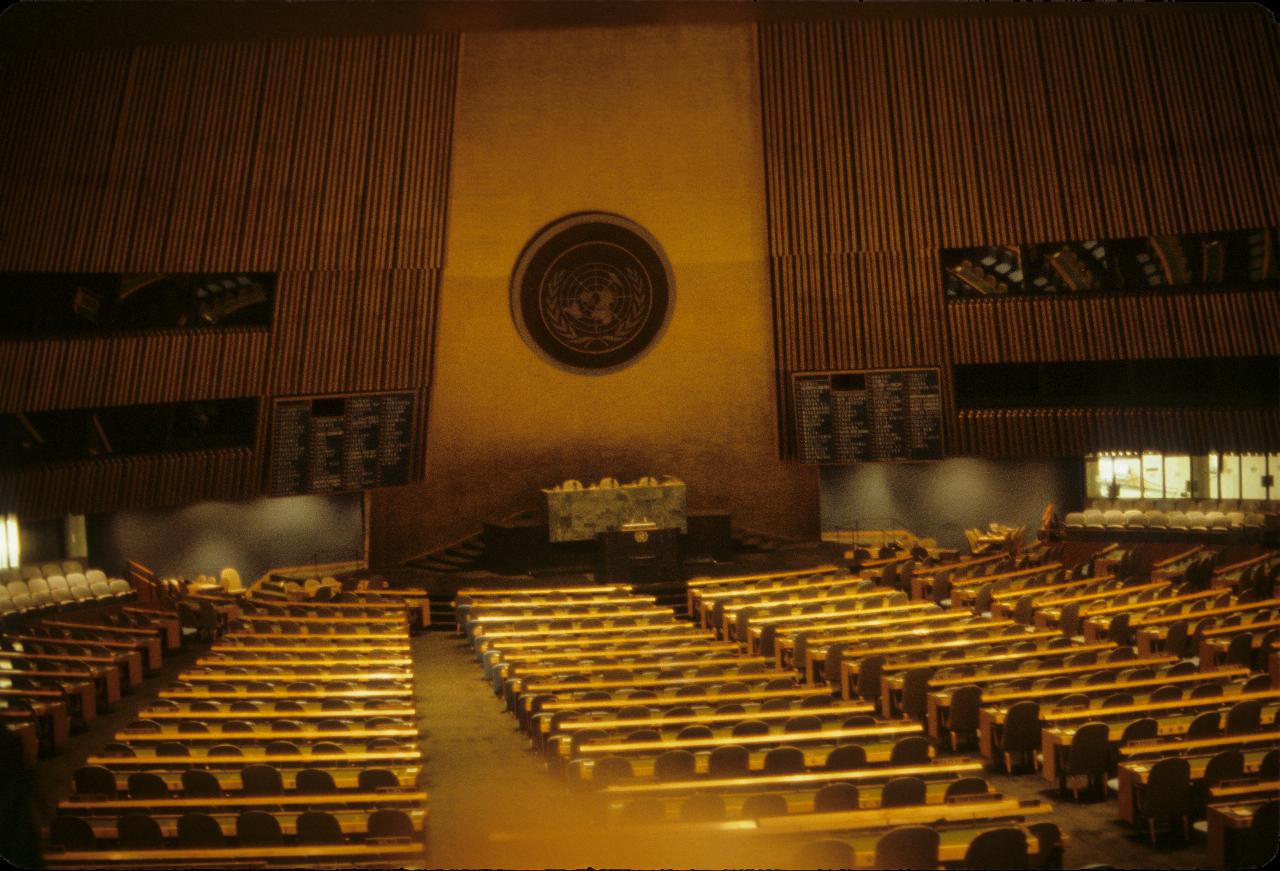 Large room with curved rows of seats, a dias at the front and a high ceiling