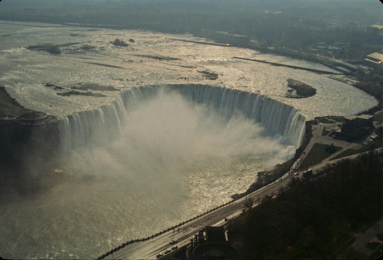 Horseshoe shaped waterfall with mist at the bottom