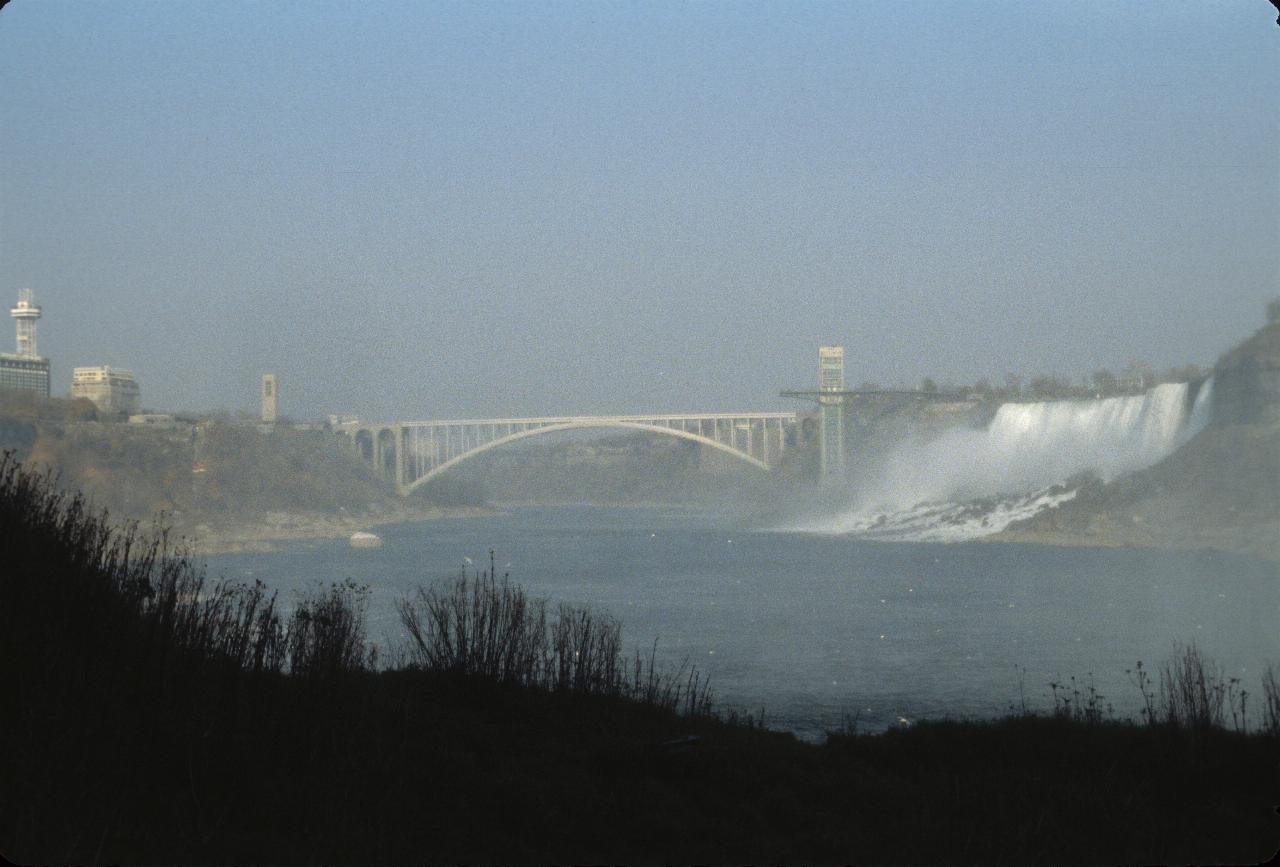 Arch bridge in distance, seen through the mist