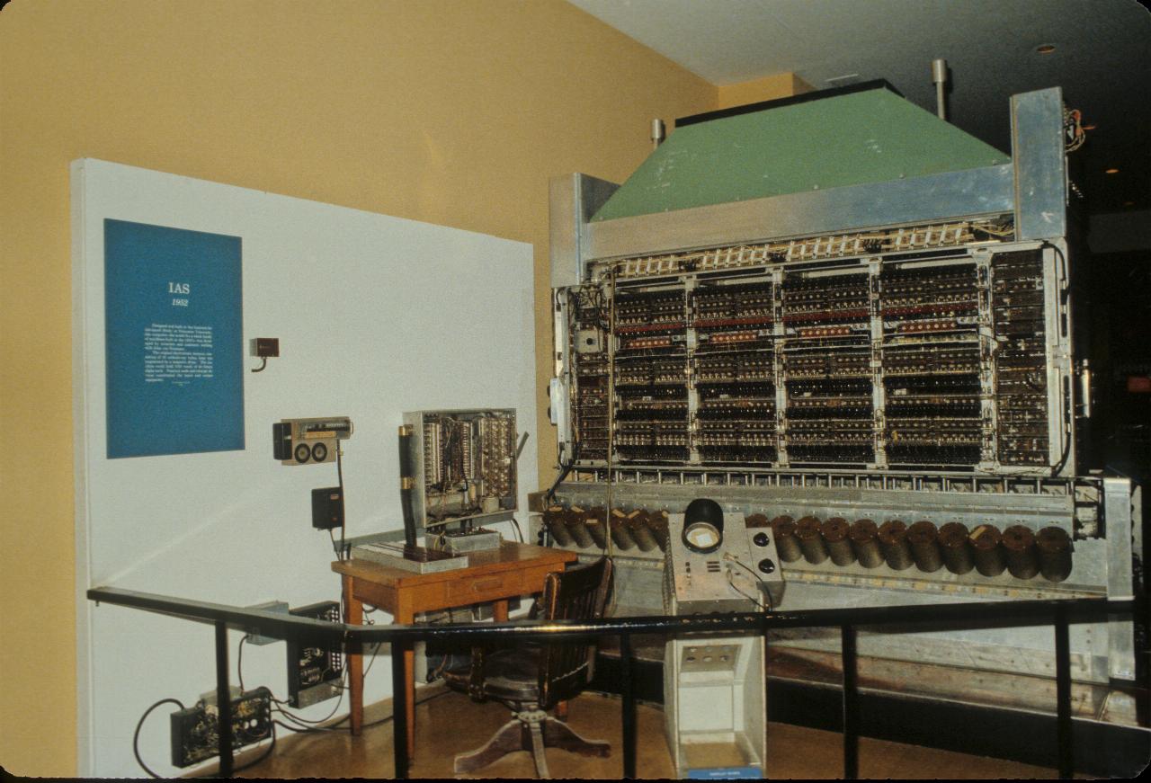 Rack of electronic components, with many black cylinders at the bottom