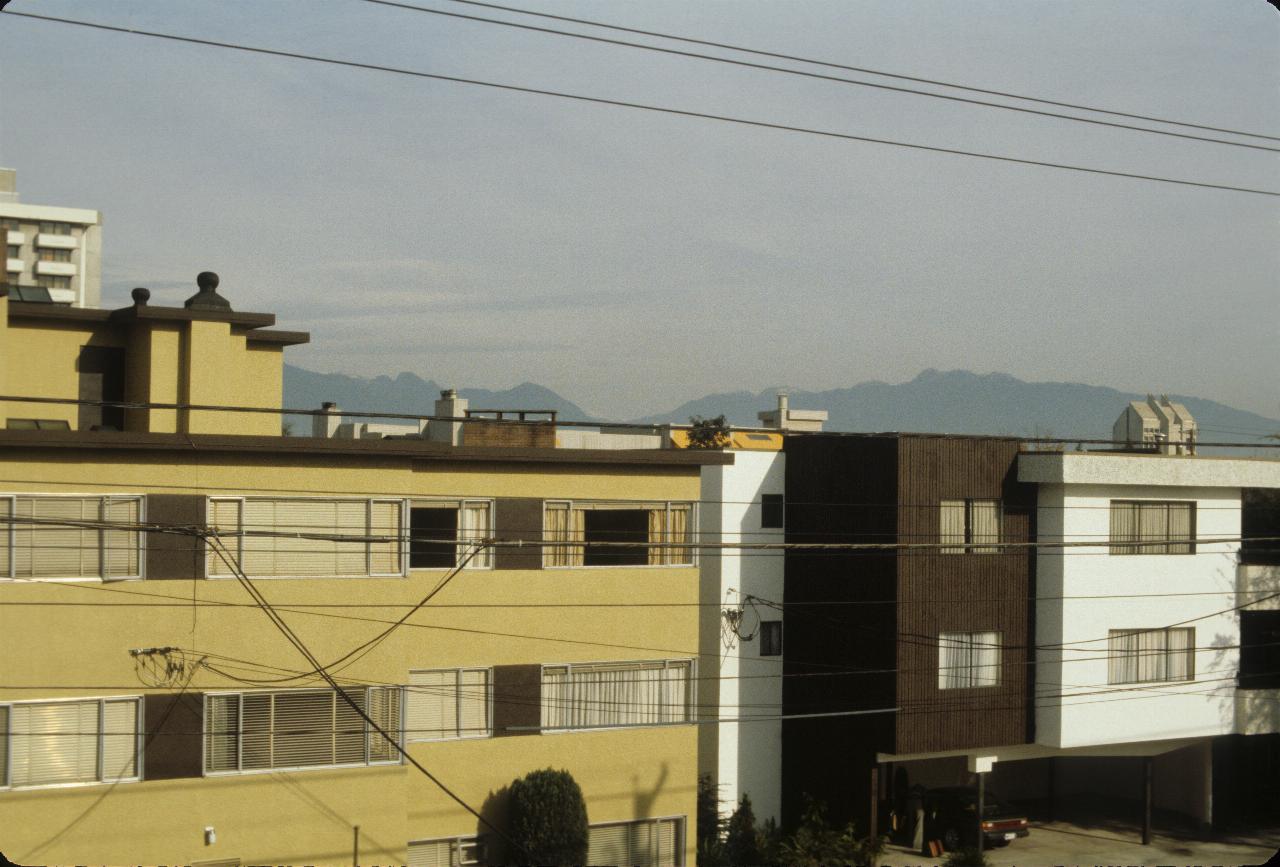 View of apartment buildings and distant mountain tops