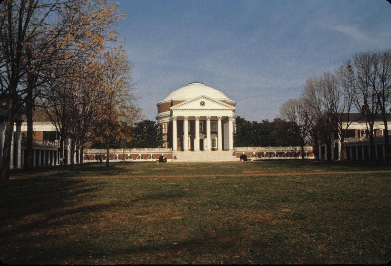 3 sides of quadrangle of low brick buildings, and a large rotunda in the far end.  Grass and trees in the middle