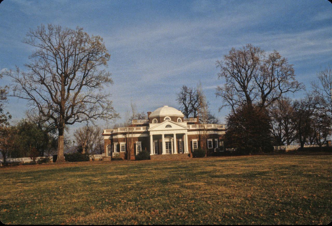 Red brick house, with white dome and pillars in the middle, plus wings just visible on each side