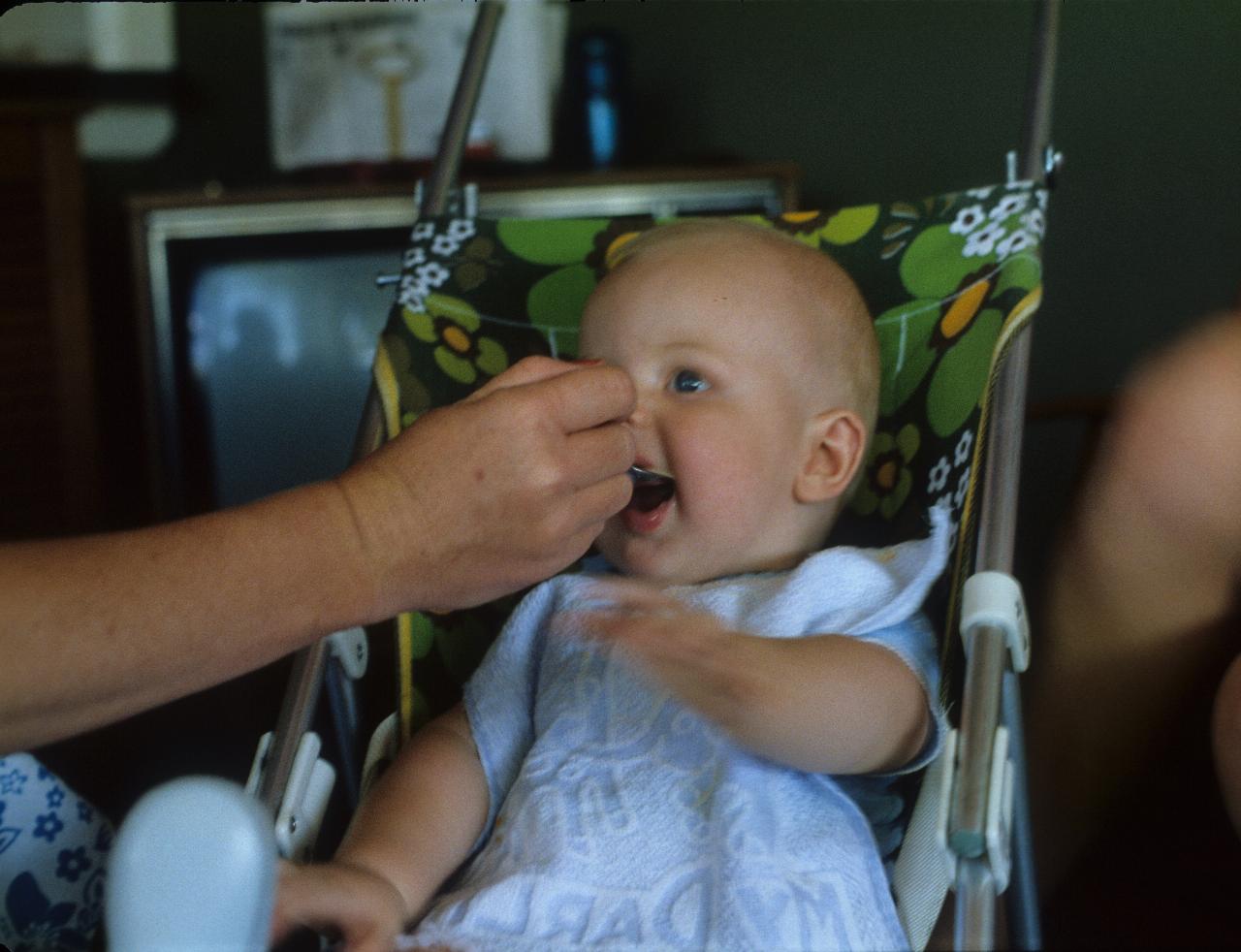 Keiran at 8 months enjoying a feed at Bardwell Park (last image on roll of film was truncated on the right)