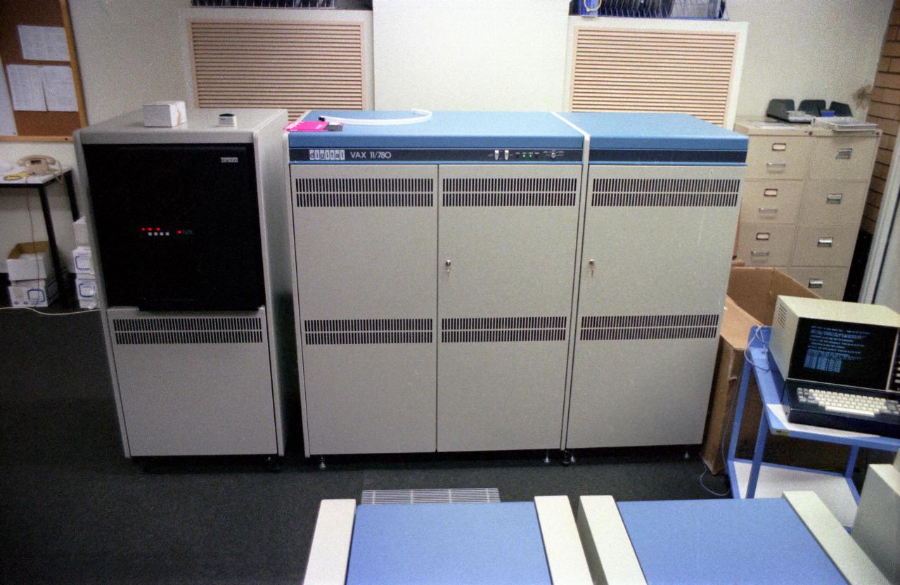 Three unit computer cabinet, gray with blue top, and another single cabinet next to it