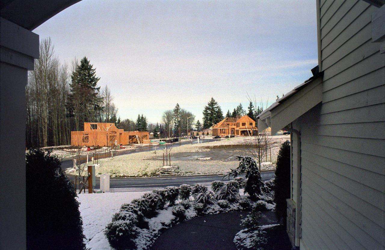 Mostly vacant building site, a couple of early stage houses