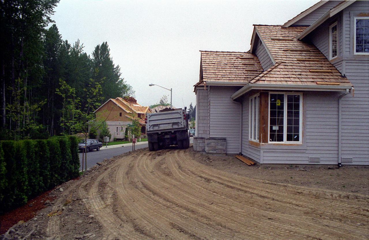 Dump truck just missing house