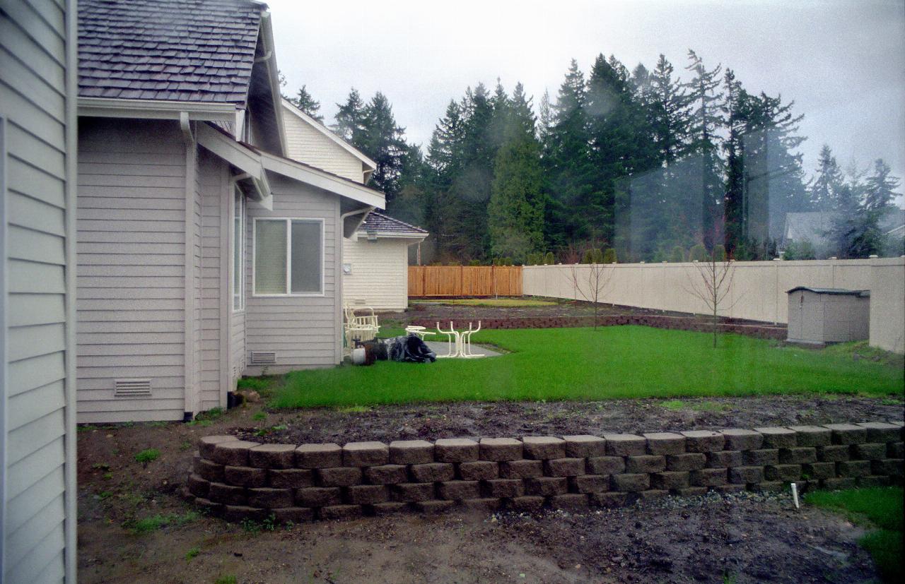 01Mar99: New retaining wall to Deal's in the rain