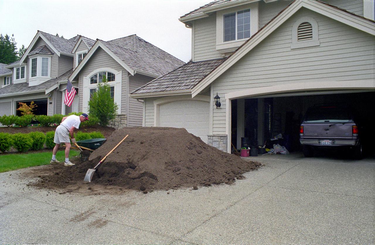 Dirt Pile on driveway, with Denny Deal shovelling