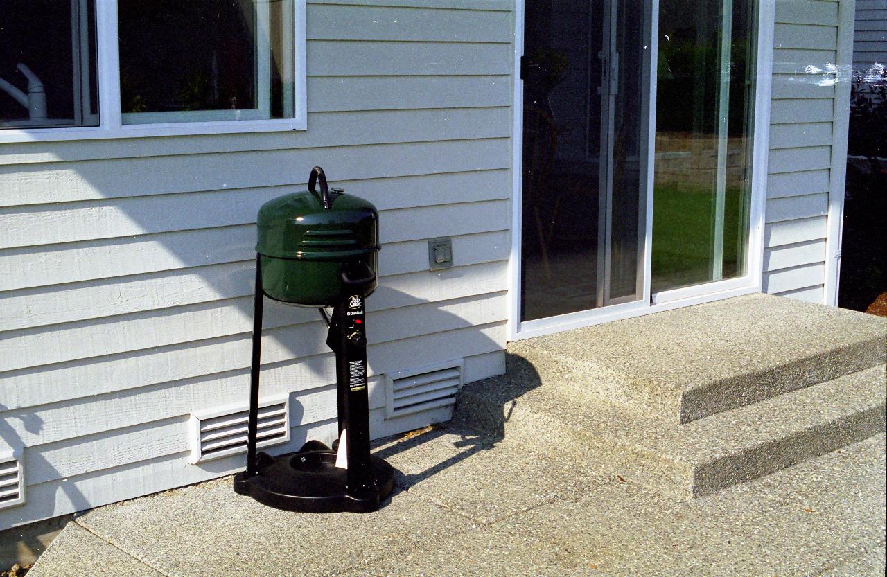 Metal cylinder with lid sitting on a tripod