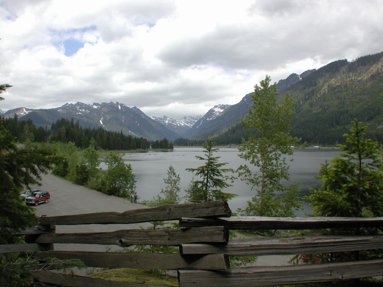 Wooden slip rail fence, lake and snow capped peaks behind