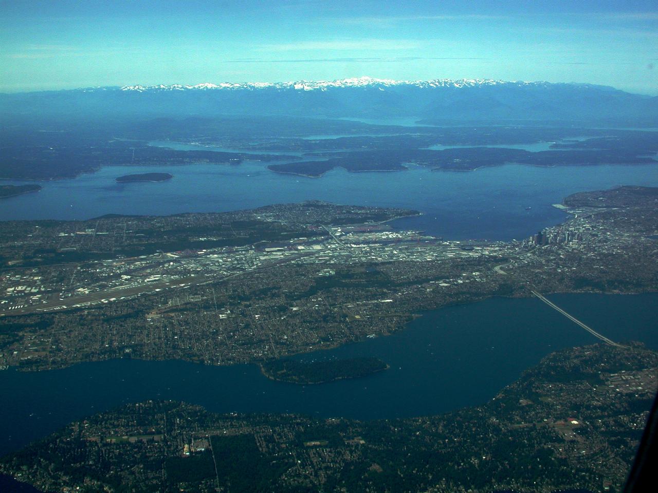 WIde angle view of land, water and distant mountains