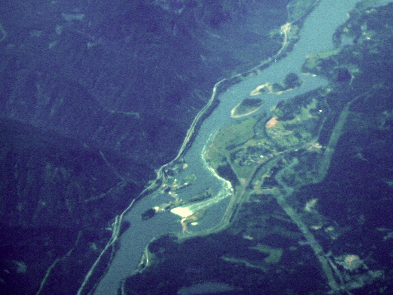 Wide river with white patch at dam spillway