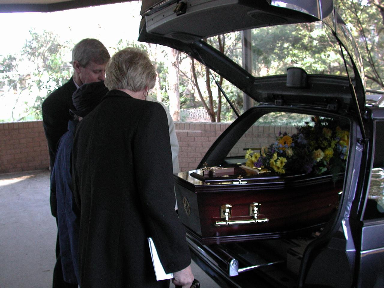 Mum, Peter and Yvonne at the rear of the hearse