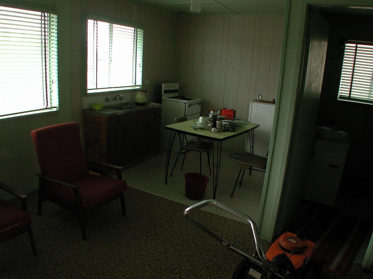 Kitchen nook with sink, stove, and laundry room with tubs