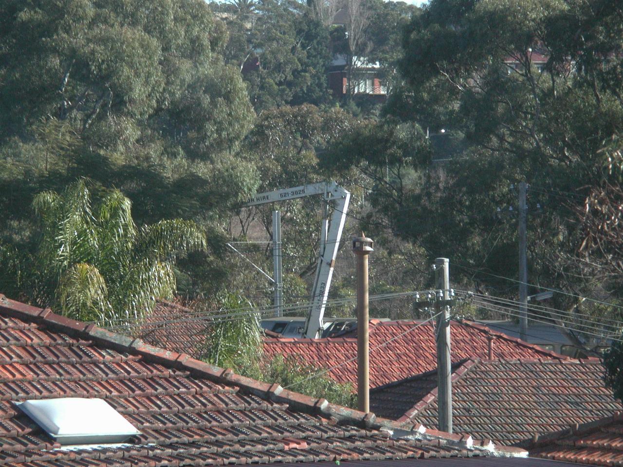 Cherry picker seen over house roofs