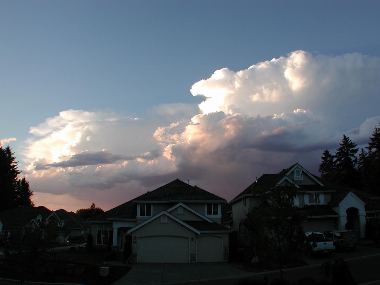 Large storm clouds behind homes across street