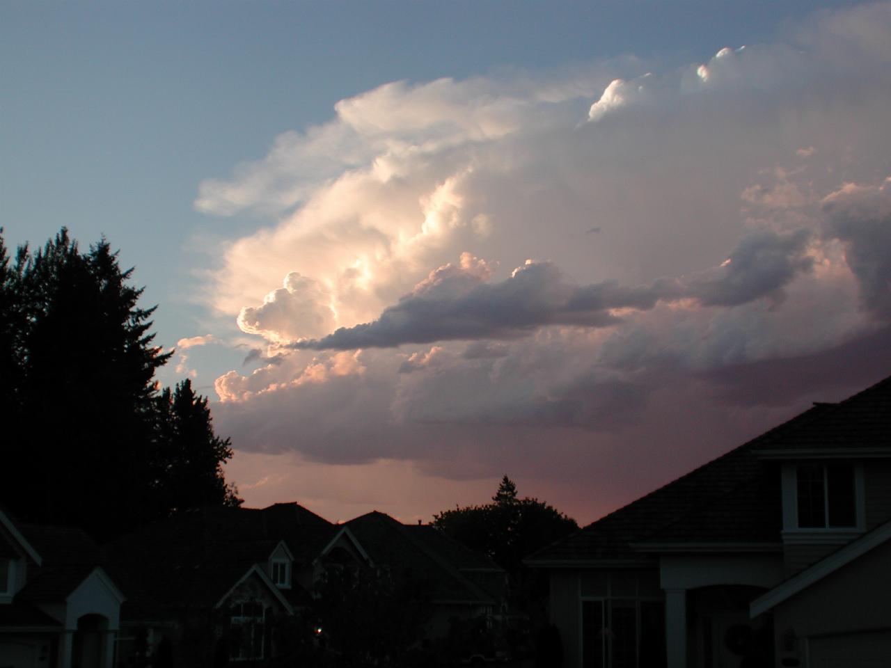 Large storm clouds behind homes across street