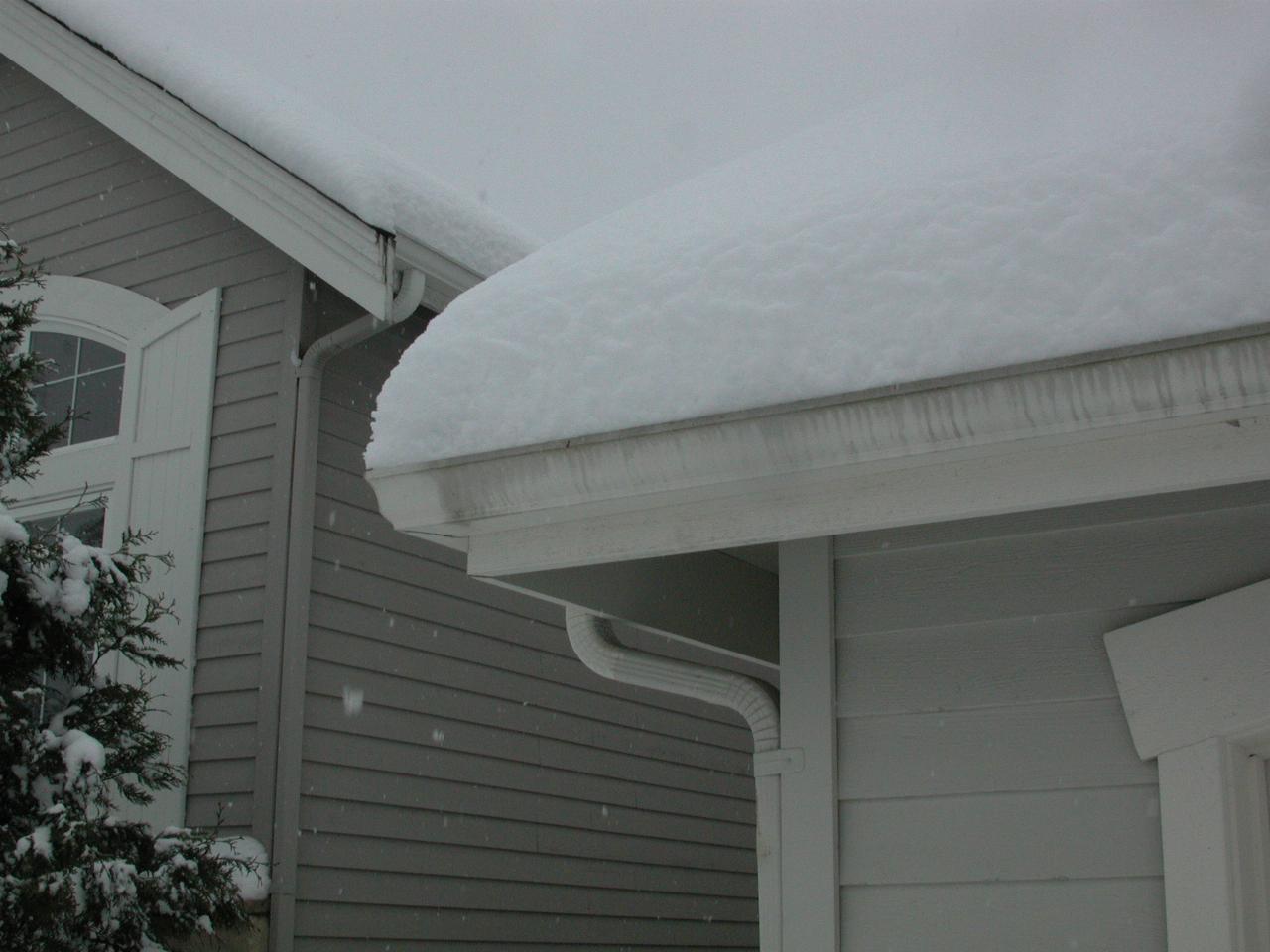 Snow accumulation on corner of garage roof