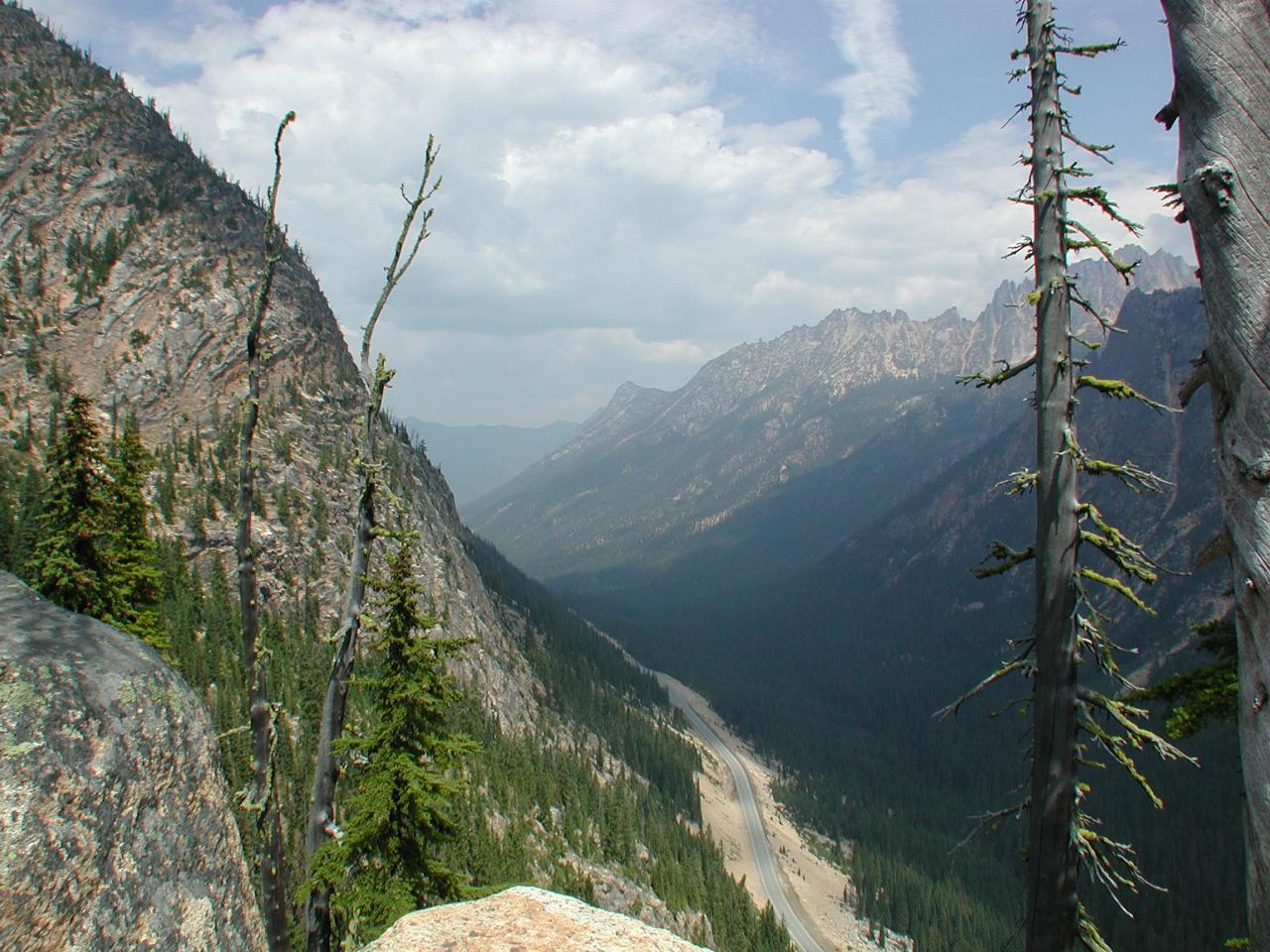 Looking down mountaineous valley with trees and road