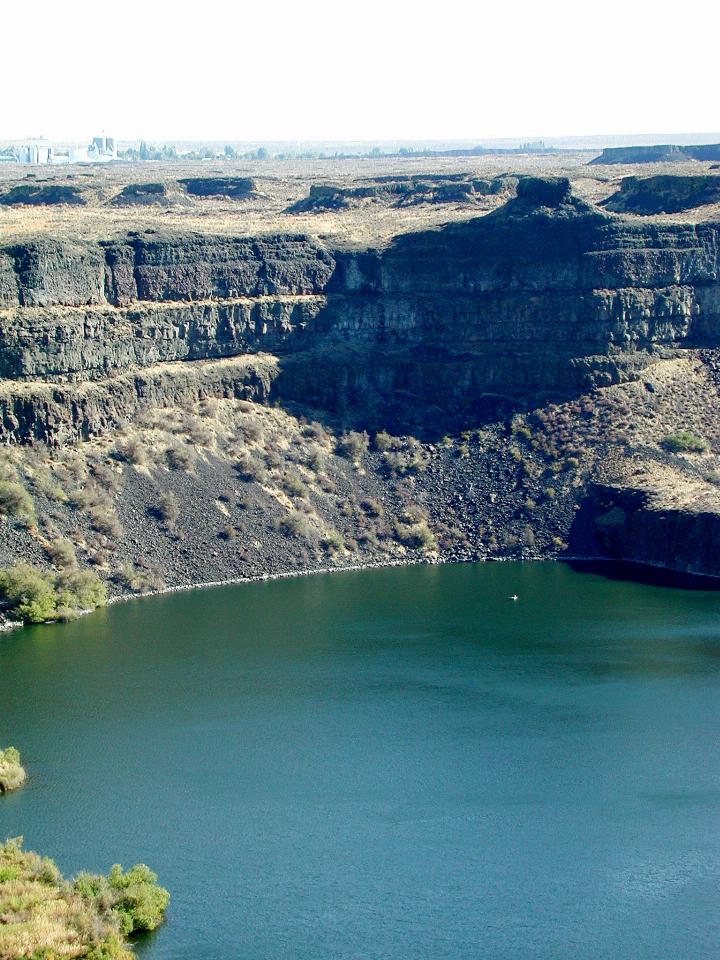 Close up of man in boat at base of Dry Falls