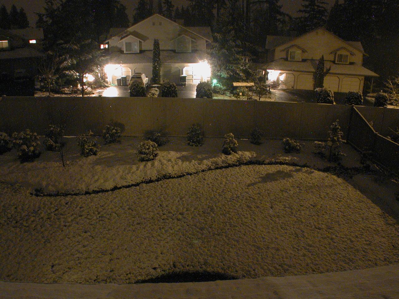 Snow continues accumulating during the night too (bright spots are water drops on the window)