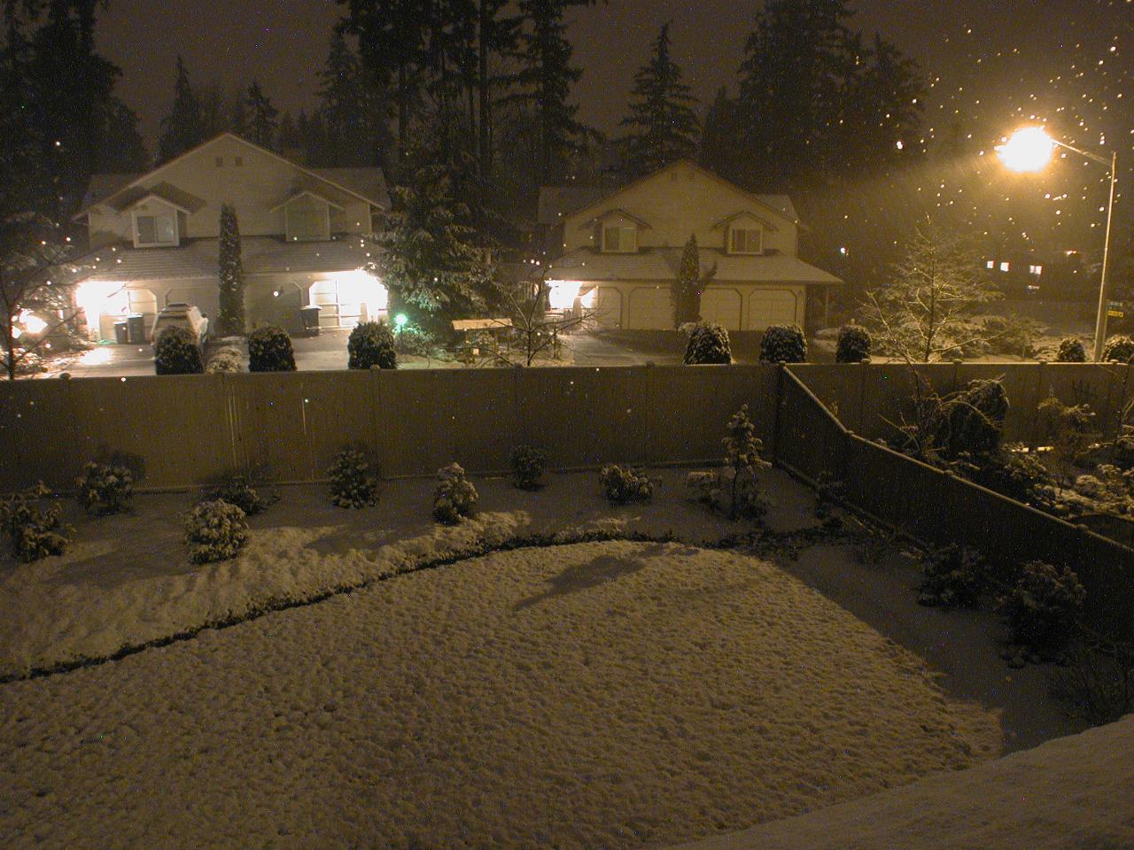 Snow continues accumulating during the night too (bright spots are water drops on the window)