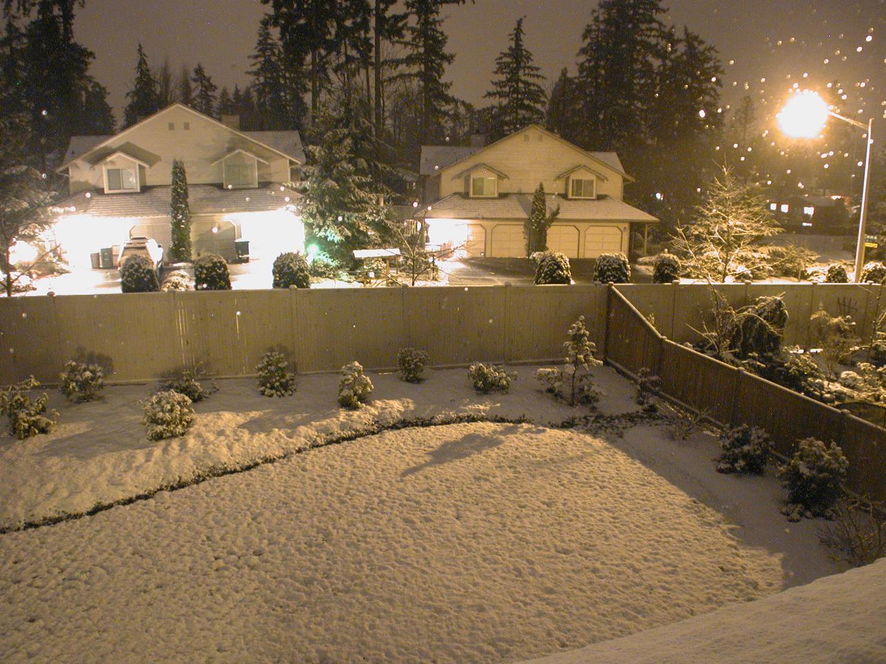 Snow continues accumulating during the night too (bright spots are water drops on the window)