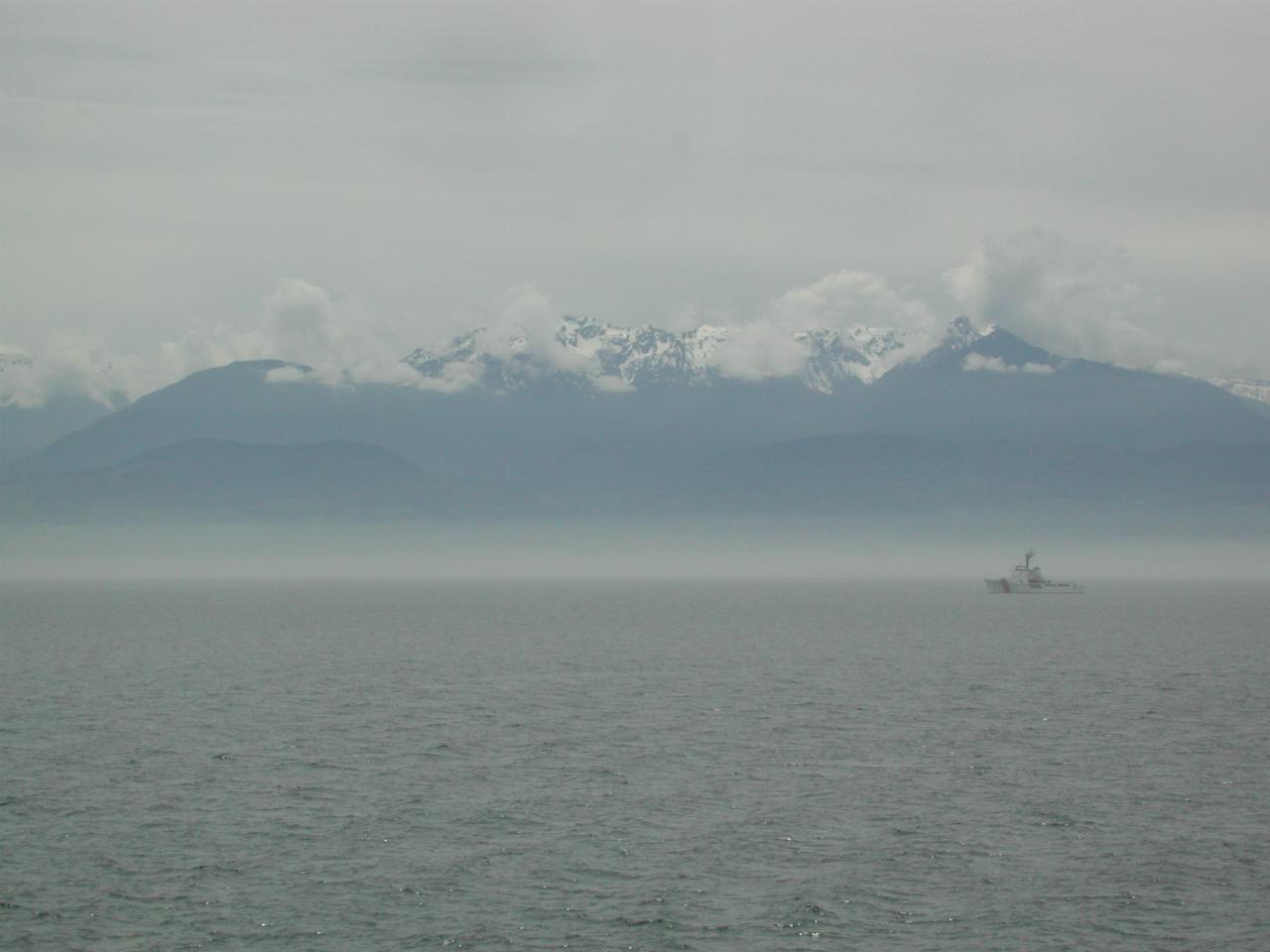 Coast Guard cutter and Olympic Mountains