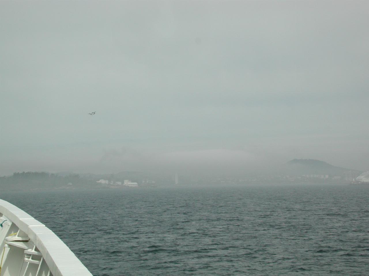 Float plane coming out of fog around Victoria Harbour, BC