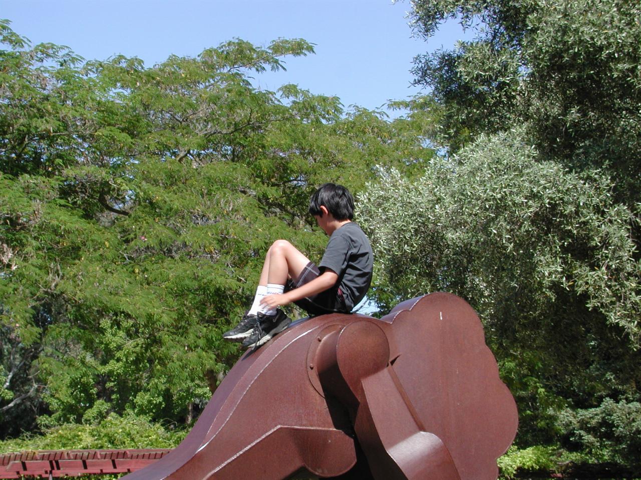 Michael Morton sitting on the sculpture