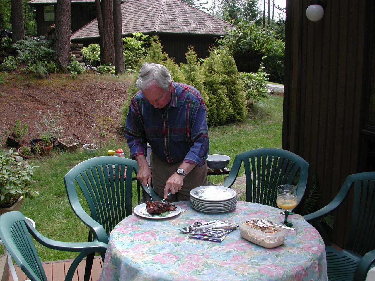 Bill cutting up the ribs (after cooking them)